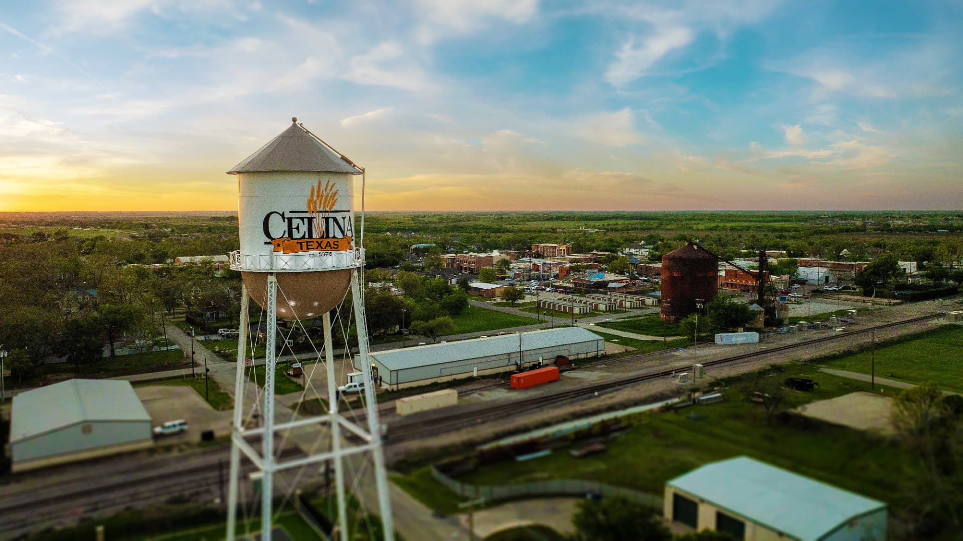 Celina, Texas water tower at sunset overlooking the historic downtown square and railroad tracks